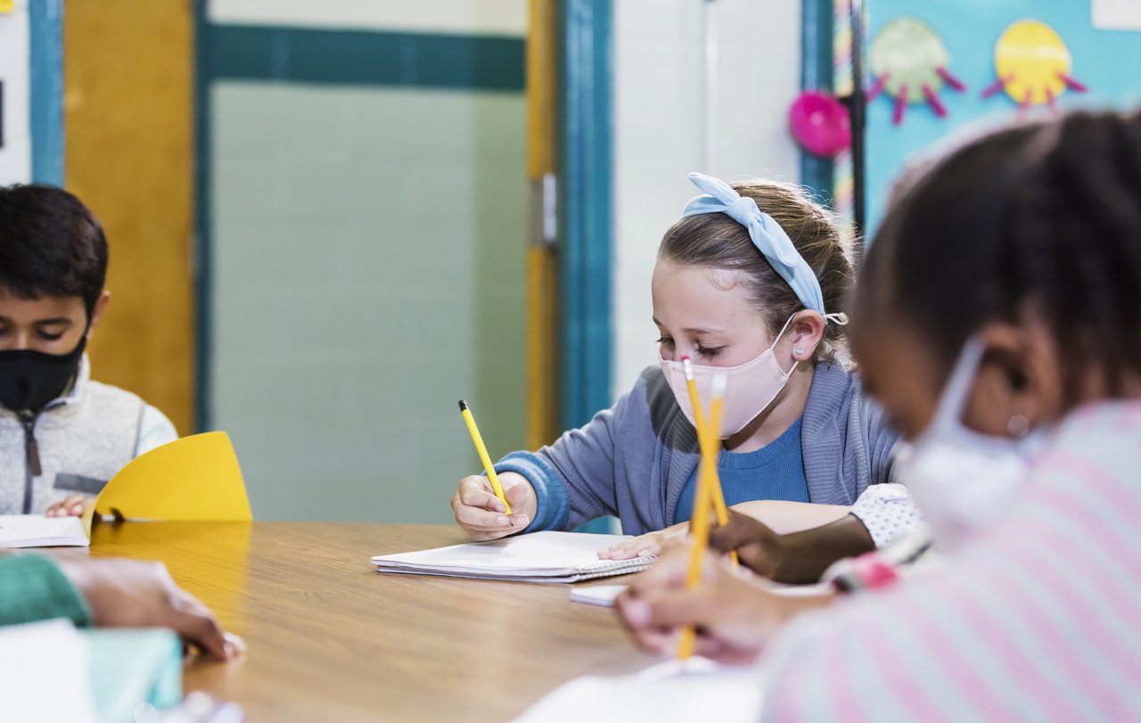 colegas de classe no ensino fundamental usando máscaras faciais